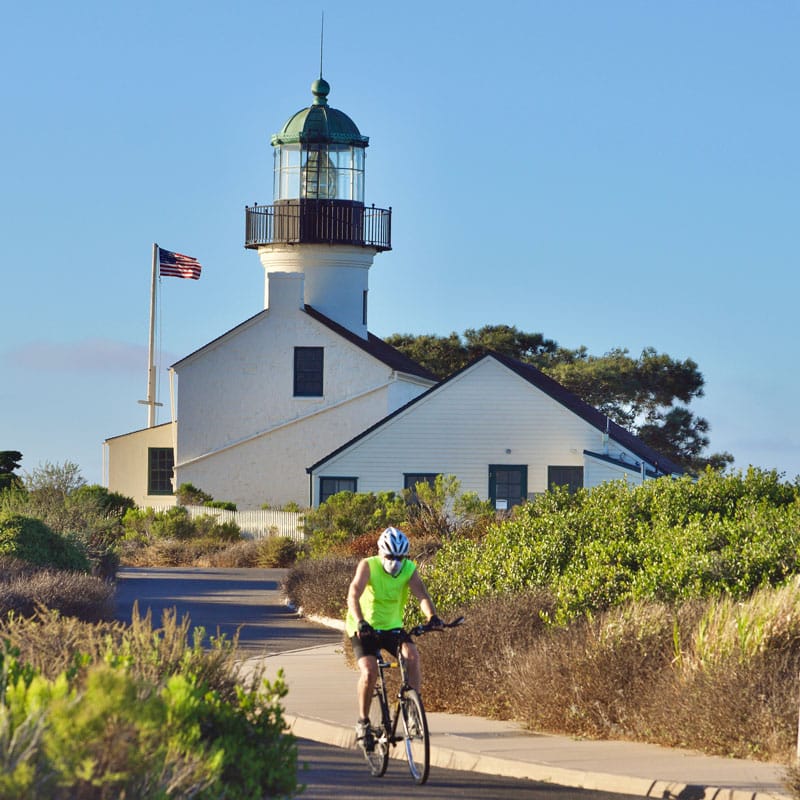 a man rides his bike while wearing a face mask to 2022 11 10 10 35 10 utc 1 | San Diego Whale Watch 3